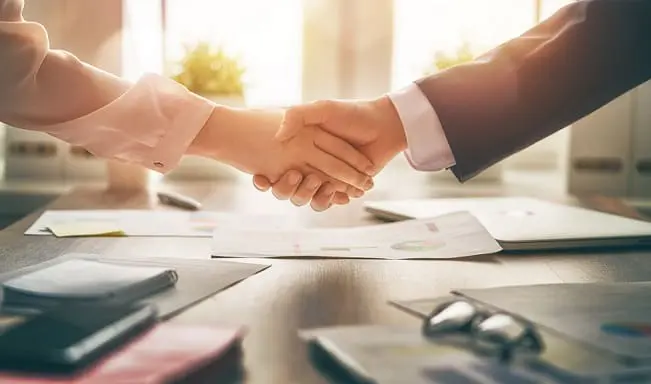 Lunch and Learn 3 Handshake over office table