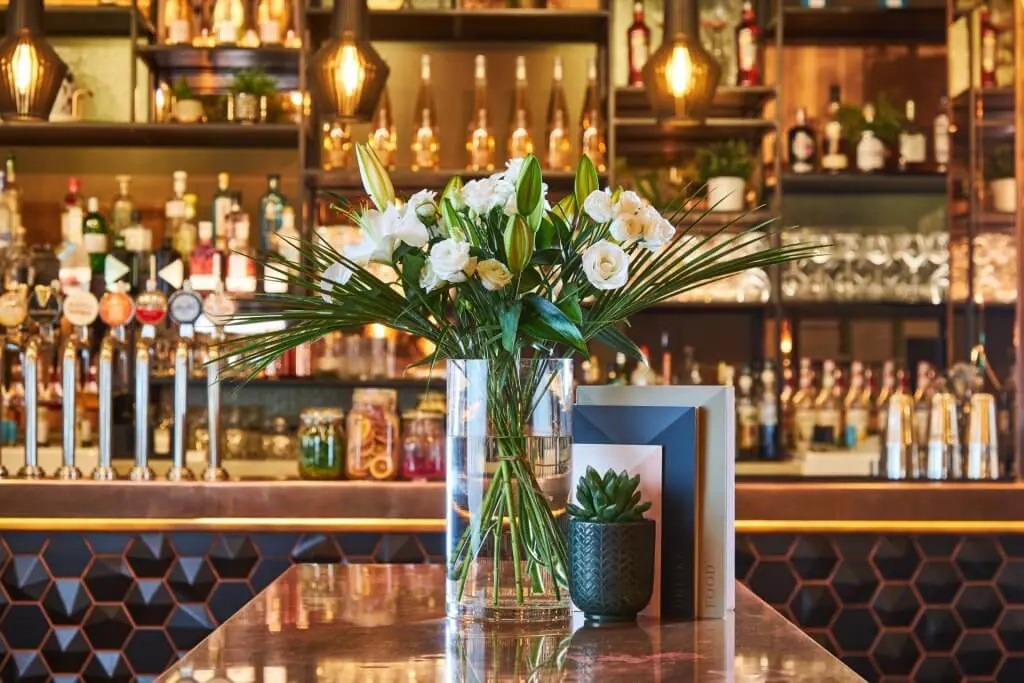 A bouquet of flowers and a vase in a nationwide pub