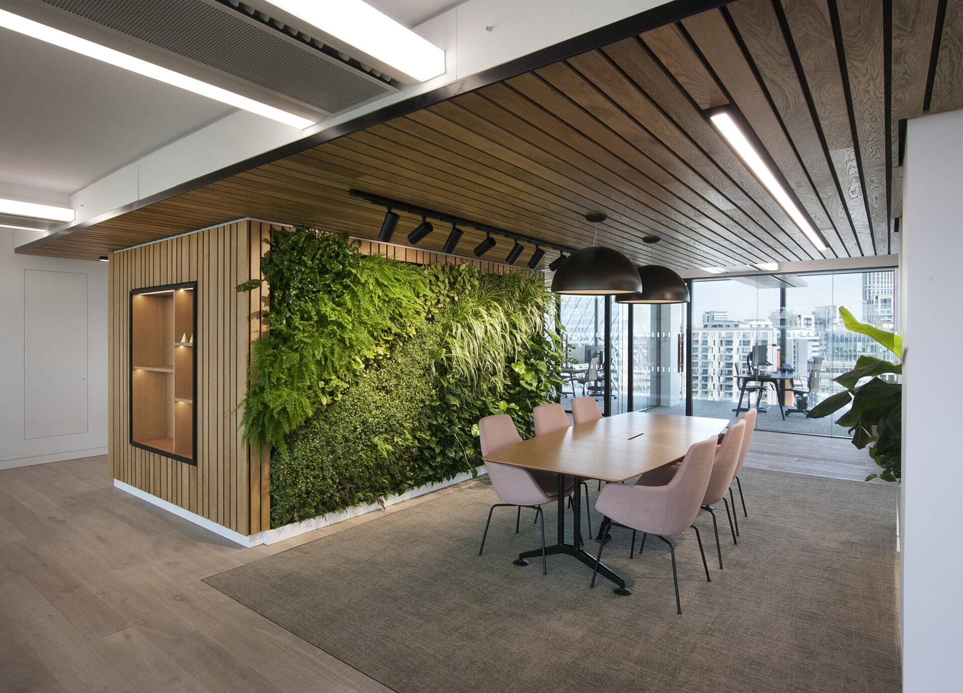Image of the stunning biophilic design of JAB Holding Company's office, featuring natural elements such as plants, living walls, and high ceilings to create a tranquil and inviting atmosphere for employees.