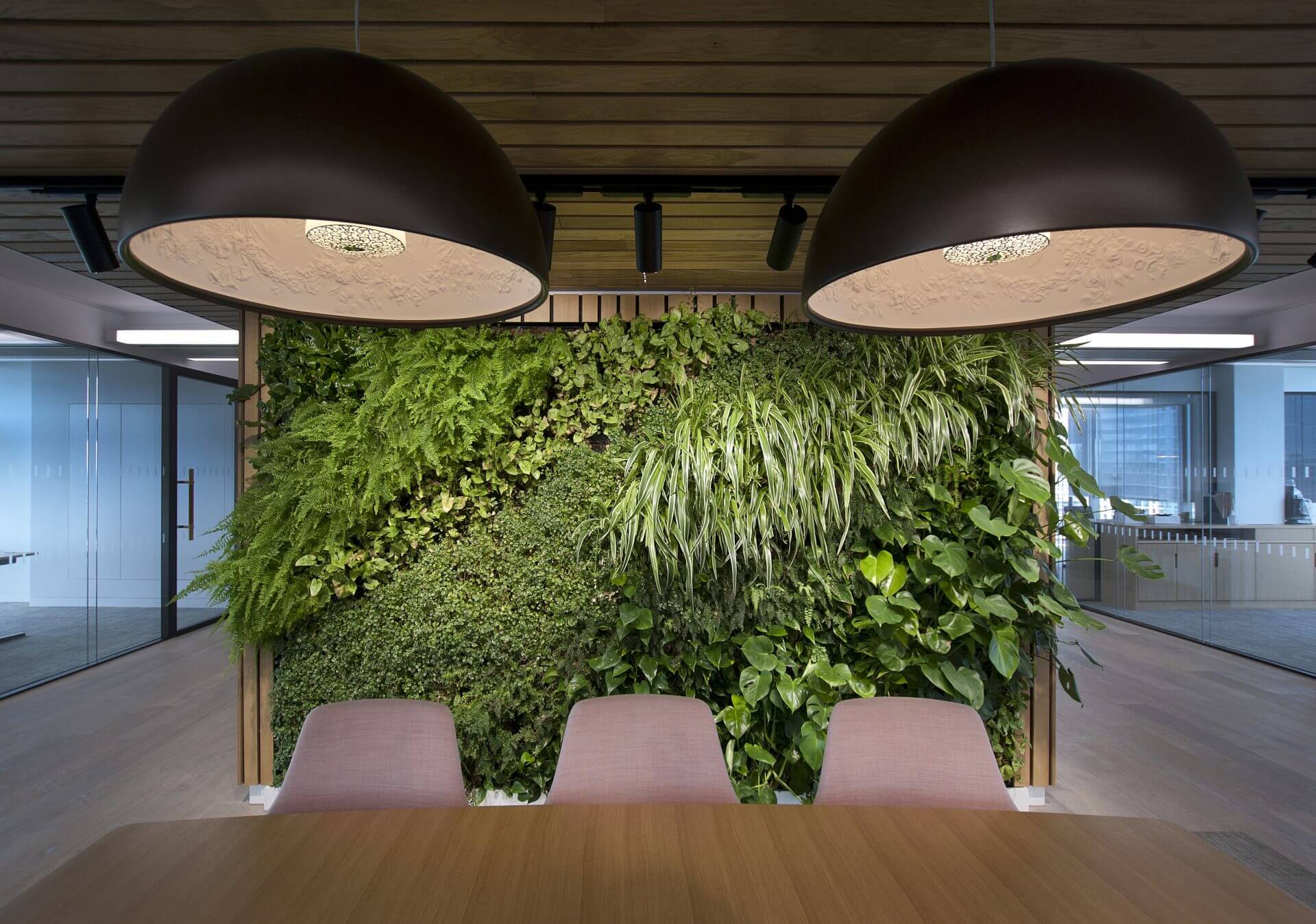 Image of the stunning biophilic design of JAB Holding Company's office, featuring natural elements such as plants, living walls, and high ceilings to create a tranquil and inviting atmosphere for employees.
