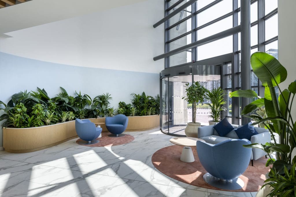 a room with blue chairs and plants