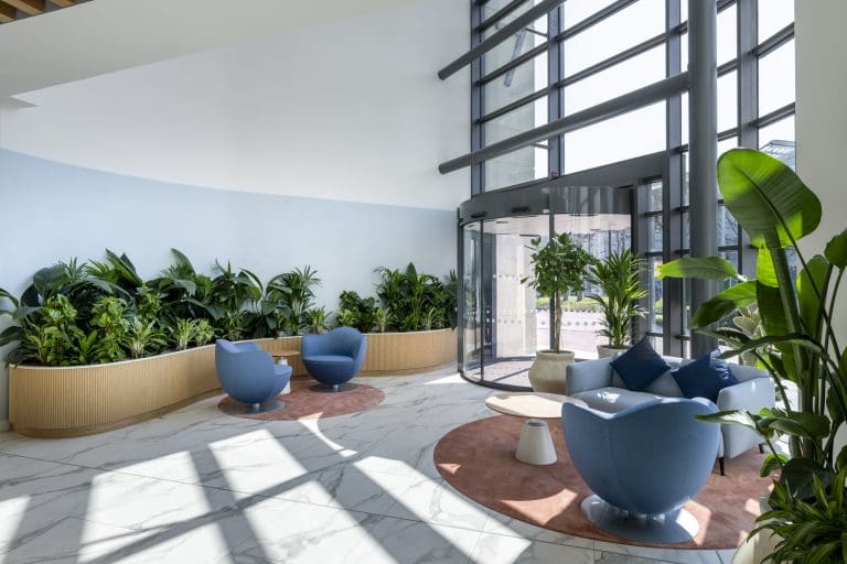 A room with blue chairs and plants
